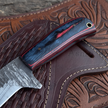 Close-up detail of the original Pakka wood handle on a handmade Damascus cowboy knife