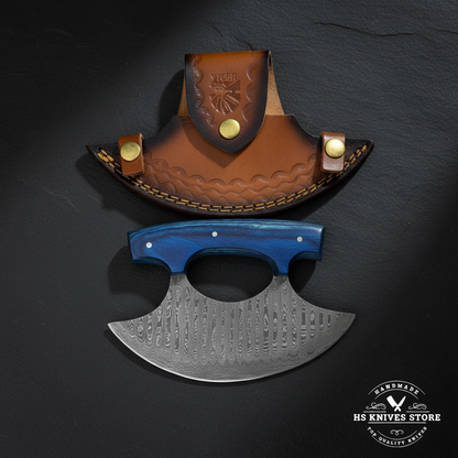 Damascus ulu knife with blue pakkawood handle displayed vertically on dark slate luxury studio background
