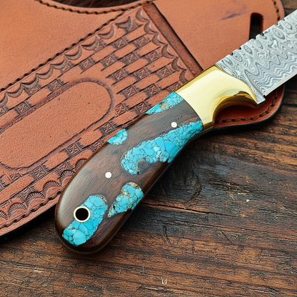 Close-up of the natural wood and resin handle on a handmade Damascus bull cutter knife