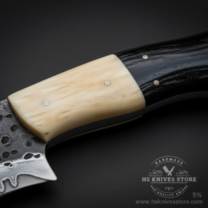 Macro view of two-tone bone and buffalo horn handle with silver pins on carbon steel hand-etched Bowie knife