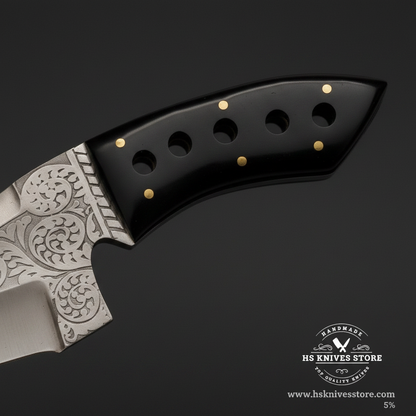 Macro view of black resin handle with 5 brass pins and 5 circular cutout holes on J2 steel skinner knife