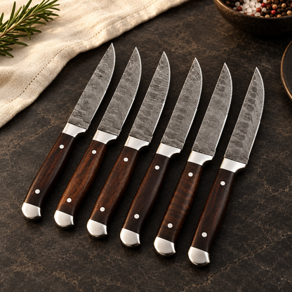 Right three-quarter view of six wood-handled Damascus steak knives on a dark dining surface