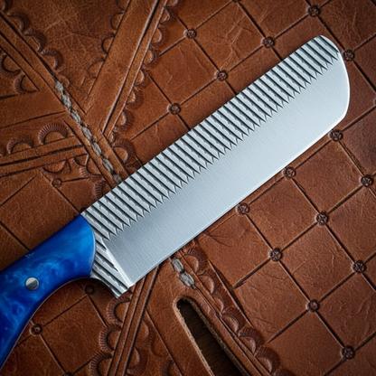 Macro detail of the line-textured 4.25-inch Rasp Tool Steel blade on a Mastercraft Custom Bull Cutter Knife