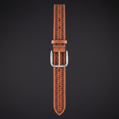 Hand-tooled tan leather western belt hanging vertical charcoal background full length silver buckle