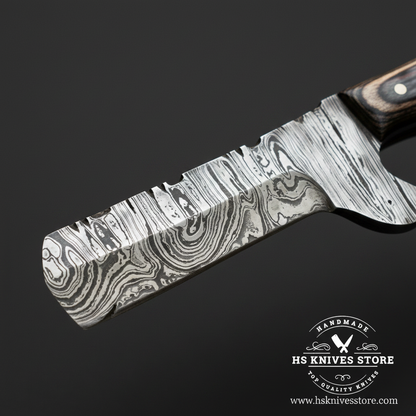 Macro close-up of Damascus steel bull cutter knife blade showing bold wavy ladder Damascus pattern and etched dark finish with bright polished edge