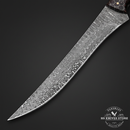 Close-up macro of Damascus steel fillet knife blade showing wavy flowing Damascus pattern and polished cutting edge and upswept tip