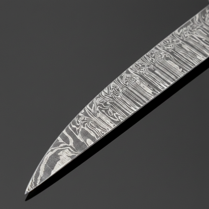 Damascus steel fillet blade close-up showing fine flowing layered Damascus pattern and sharp pointed tip