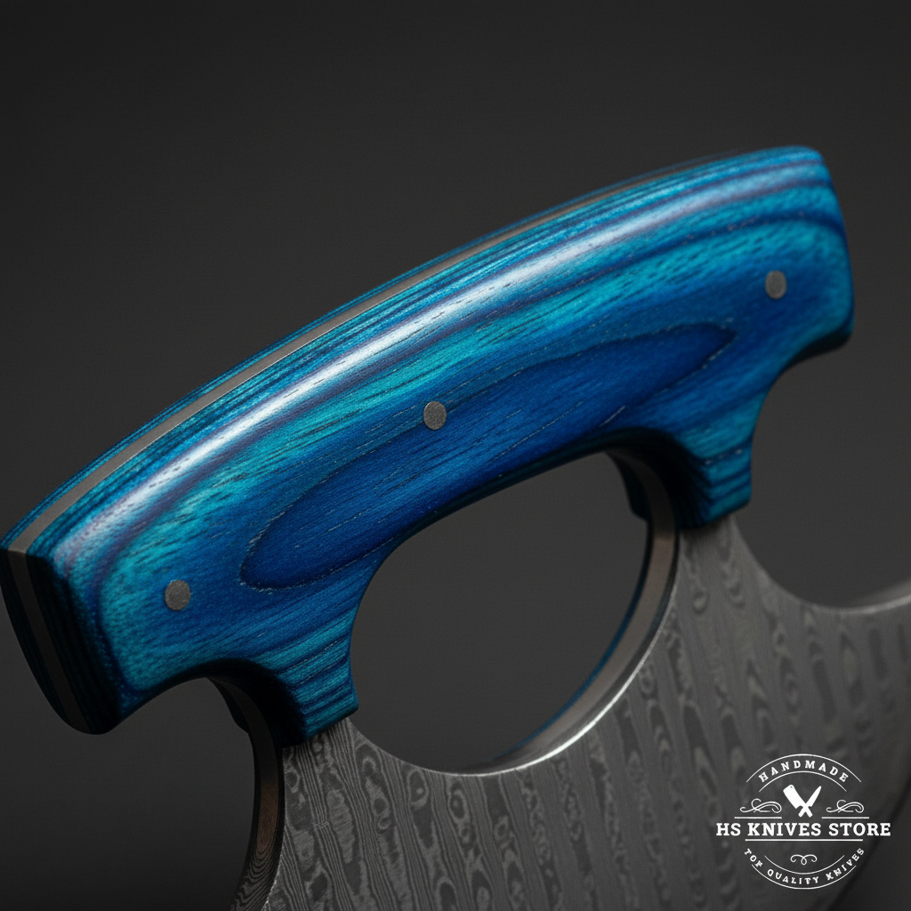 Macro close-up of deep royal blue pakkawood ulu knife handle with textured grain open finger loop and 2 steel pins