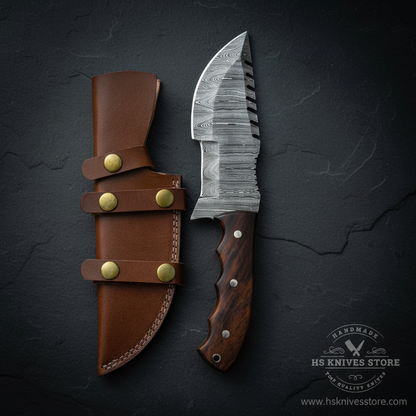 A fixed-blade knife with a patterned steel blade and dark wood handle is displayed beside a brown leather sheath with brass snaps, set on a dark textured background. A H8 Knives Store watermark is visible in the lower right corner.