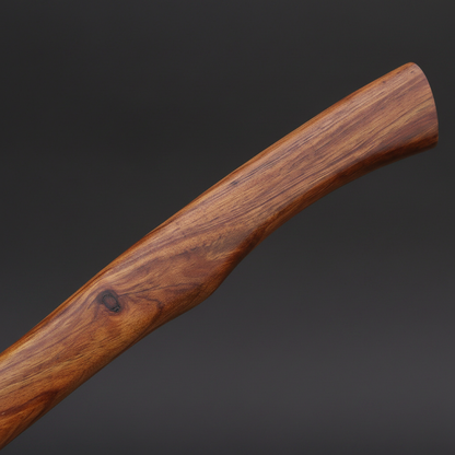 Natural rosewood axe handle close-up macro showing wood grain and natural wood knot detail