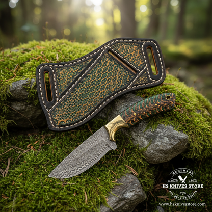 Green pinecone Damascus Skinner Knife and scout sheath resting on mossy rocks in a forest