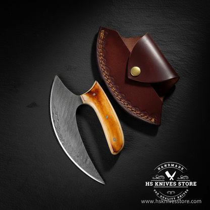Damascus ulu knife with amber bone handle displayed vertically on dark slate luxury studio background