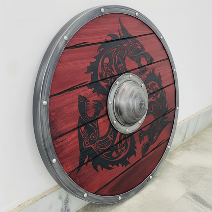 Angled detail of silver rim, evenly spaced rivets, red plank texture, and dark Norse artwork on a Viking shield