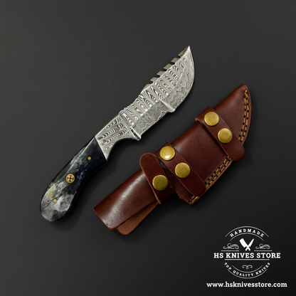 Damascus gut hook knife with bone handle and dark brown leather sheath mirror view on dark charcoal background