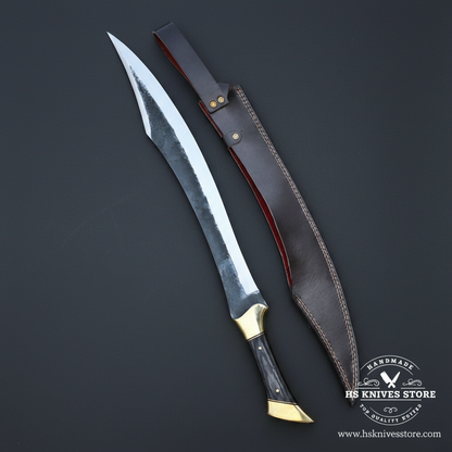 Curved carbon steel Falcata collector blade with black handle and brown leather sheath on charcoal background