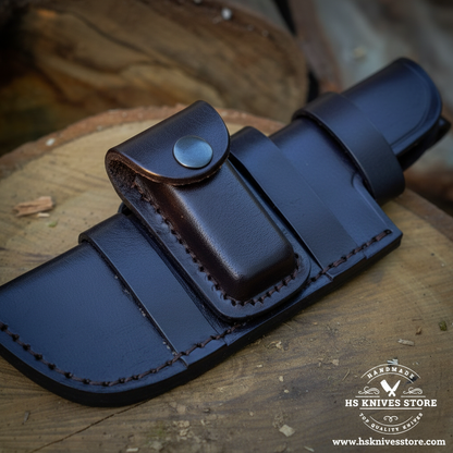 Close-up of dark leather knife sheath with attached snap-button pouch and black stitching for Damascus tracker knife
