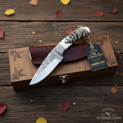 D2 steel engraved skinner knife flat lay with walnut gift box hang tag and autumn leaves on dark rustic wood surface