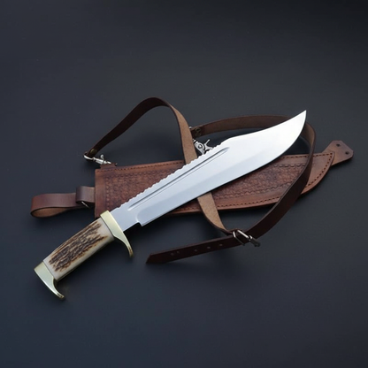 Handmade 16 inch American classic Bowie knife with stag antler handle and brass guard, dark charcoal studio background right facing