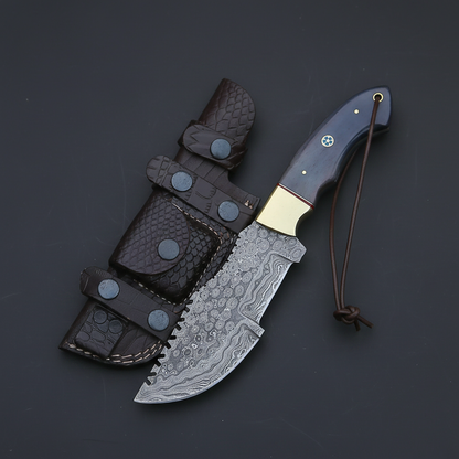 Damascus tracker knife blue colored bone handle brass bolster dark charcoal gray studio mirror left facing