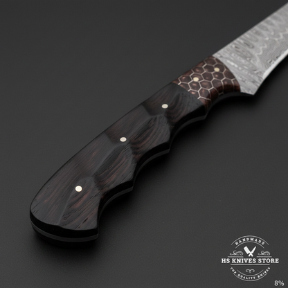 Macro view of dark ebony wood handle with hexagonal honeycomb pattern inlay and two silver pins on Damascus fillet knife