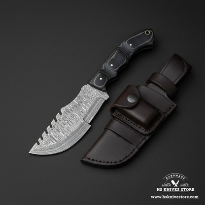 Damascus tracker knife with black Micarta handle and leather sheath mirror view on dark charcoal background