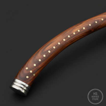 Macro detail of the curved natural hardwood shaft with brass pin inlays and metallic end cap