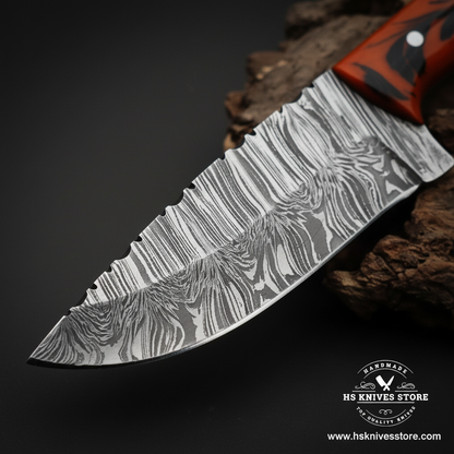 Close-up of Damascus steel skinner knife blade showing layered wavy Damascus pattern and mirror polished edge
