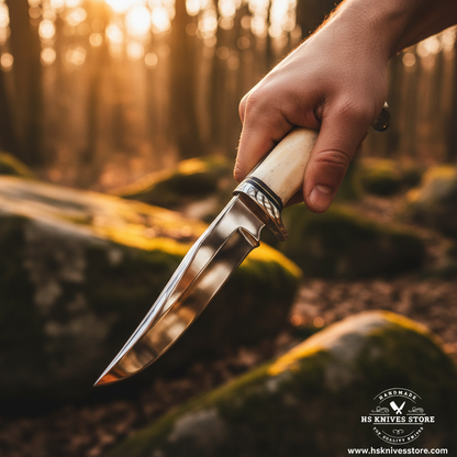 Hand gripping bone handle J2 steel hunting knife with double chrome bolster in outdoor forest action shot with golden hour light