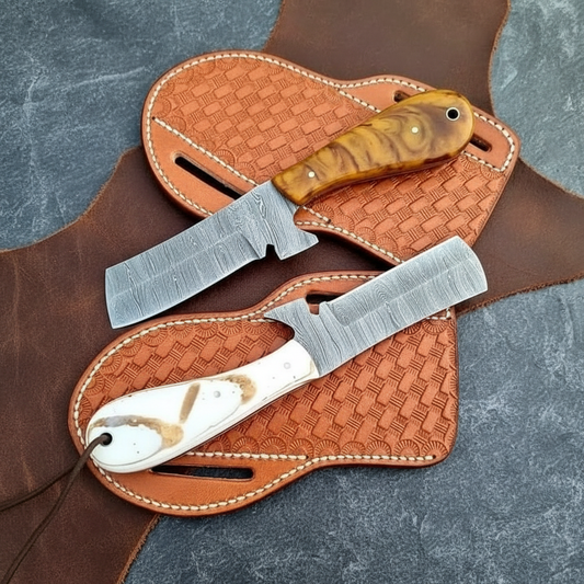 Back and reverse view of both full-tang Damascus Bull Cutter Knives with epoxy resin handles and separate leather sheaths