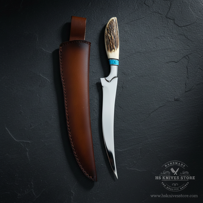 Vertical luxury shot of spring steel fillet knife stag antler handle blue turquoise spacer on dark slate background with dark chocolate brown leather sheath