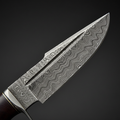 Damascus steel blade close-up showing wavy water-flow layered pattern and sharp drop point edge