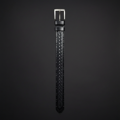 Hand-tooled black leather western belt hanging vertical charcoal background full length