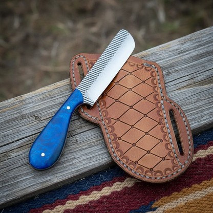 Top-down view of a Mastercraft Custom Bull Cutter Knife and its pancake leather sheath arranged on a cowboy saddle blanket