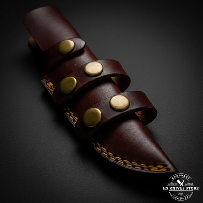 Close-up of dark burgundy leather belt knife sheath with three leather loops and four brass rivets and gold braided stitching macro detail