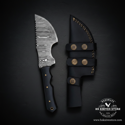 Opposite-facing black Micarta Damascus tracker hunting knife with leather sheath in studio lighting