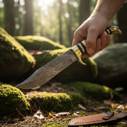 Hands holding Damascus Bowie knife with white burned bone handle in outdoor forest environment