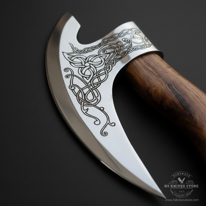 Close-up macro of Celtic Viking knotwork etching on polished mirror finish crescent ulu pizza axe blade detail