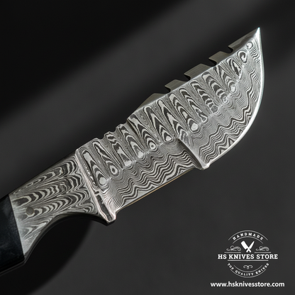Close-up of Damascus steel gut hook knife blade showing bold layered wavy Damascus pattern and gut hook notch on spine and Damascus bolster macro detail