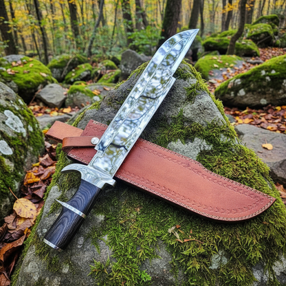 D2 steel Bowie knife with black hardwood handle and leather sheath resting on mossy rocks in outdoor forest setting