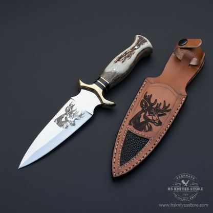 D2 steel dagger knife with stag antler handle and deer tooled leather sheath on dark charcoal studio background mirror direction