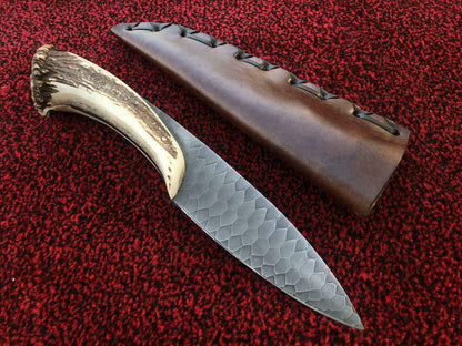 Camping knife with leather sheath and carbon steel blade