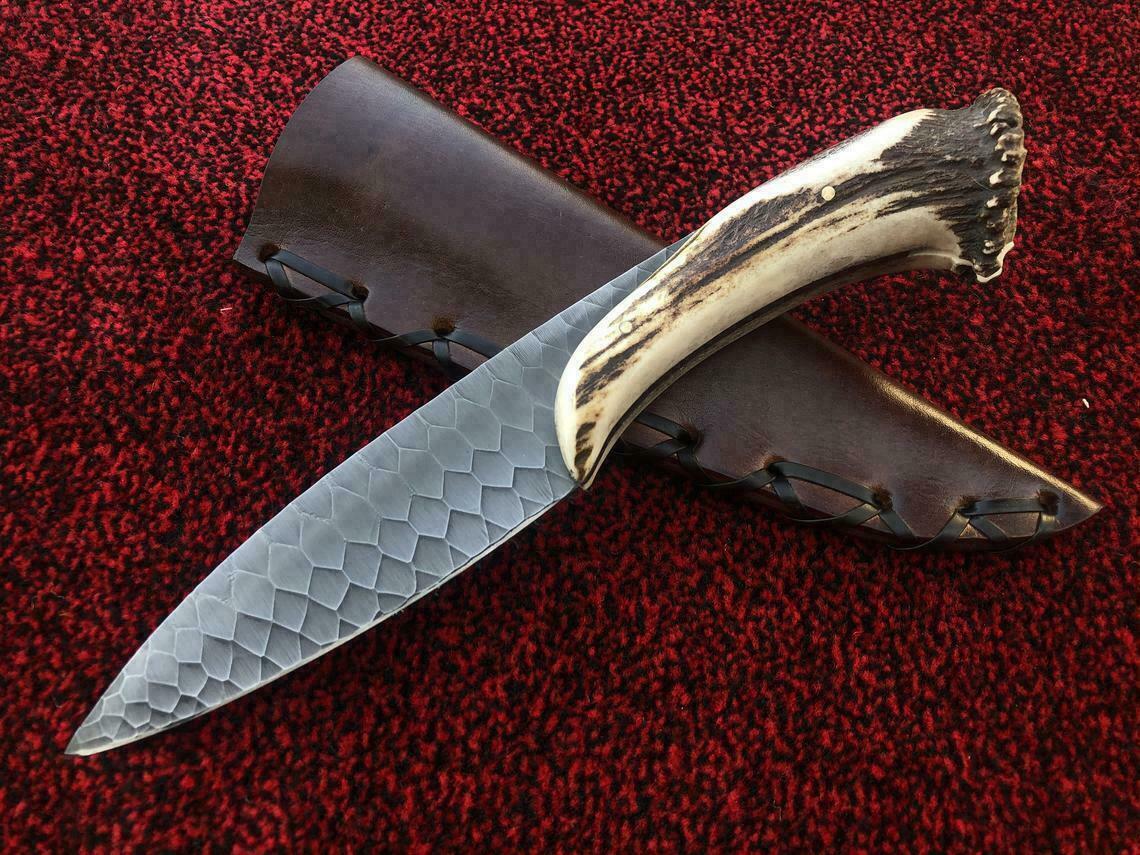 Custom handmade hunting knife featuring carbon steel blade and stag style handle design
