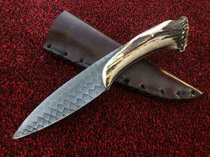 Custom handmade hunting knife featuring carbon steel blade and stag style handle design